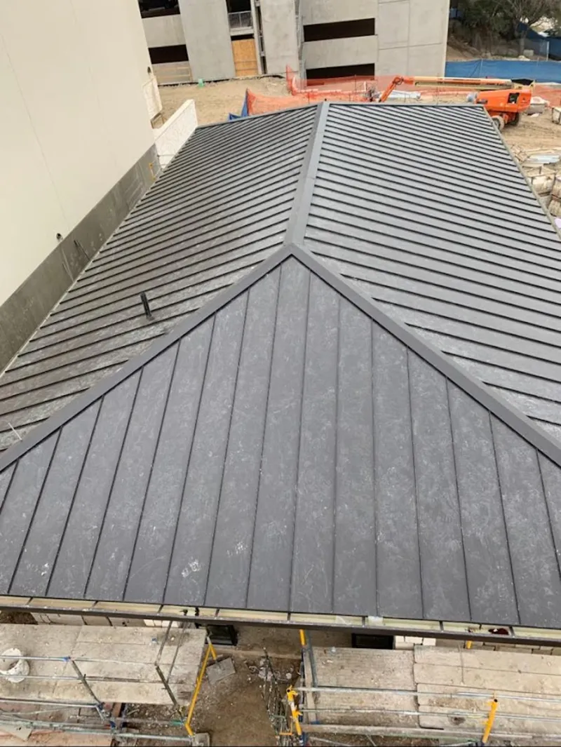 Commercial metal roof construction with crane equipment in Long Grove