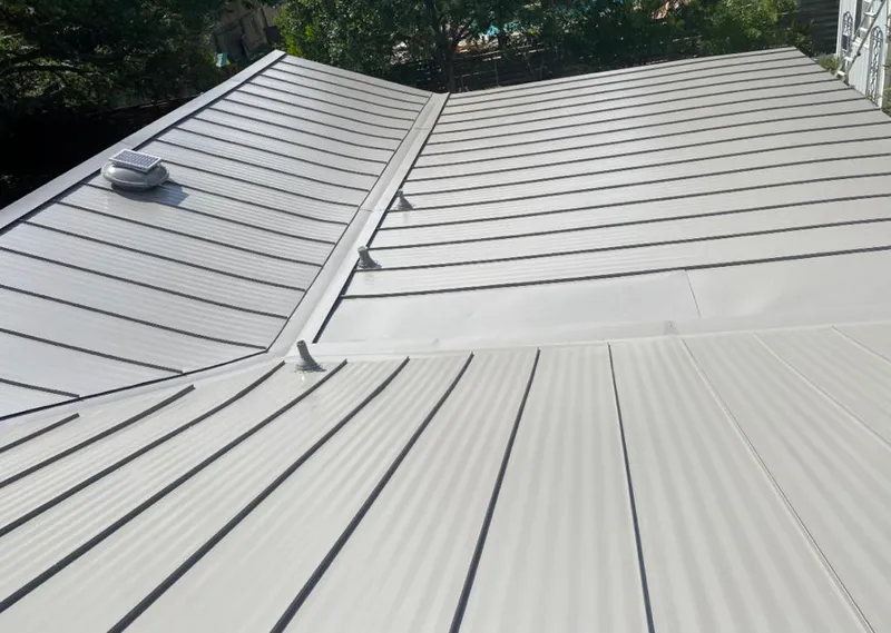 Solar attic fan installed on a metal roof for Roof Ventilation in Long Grove
